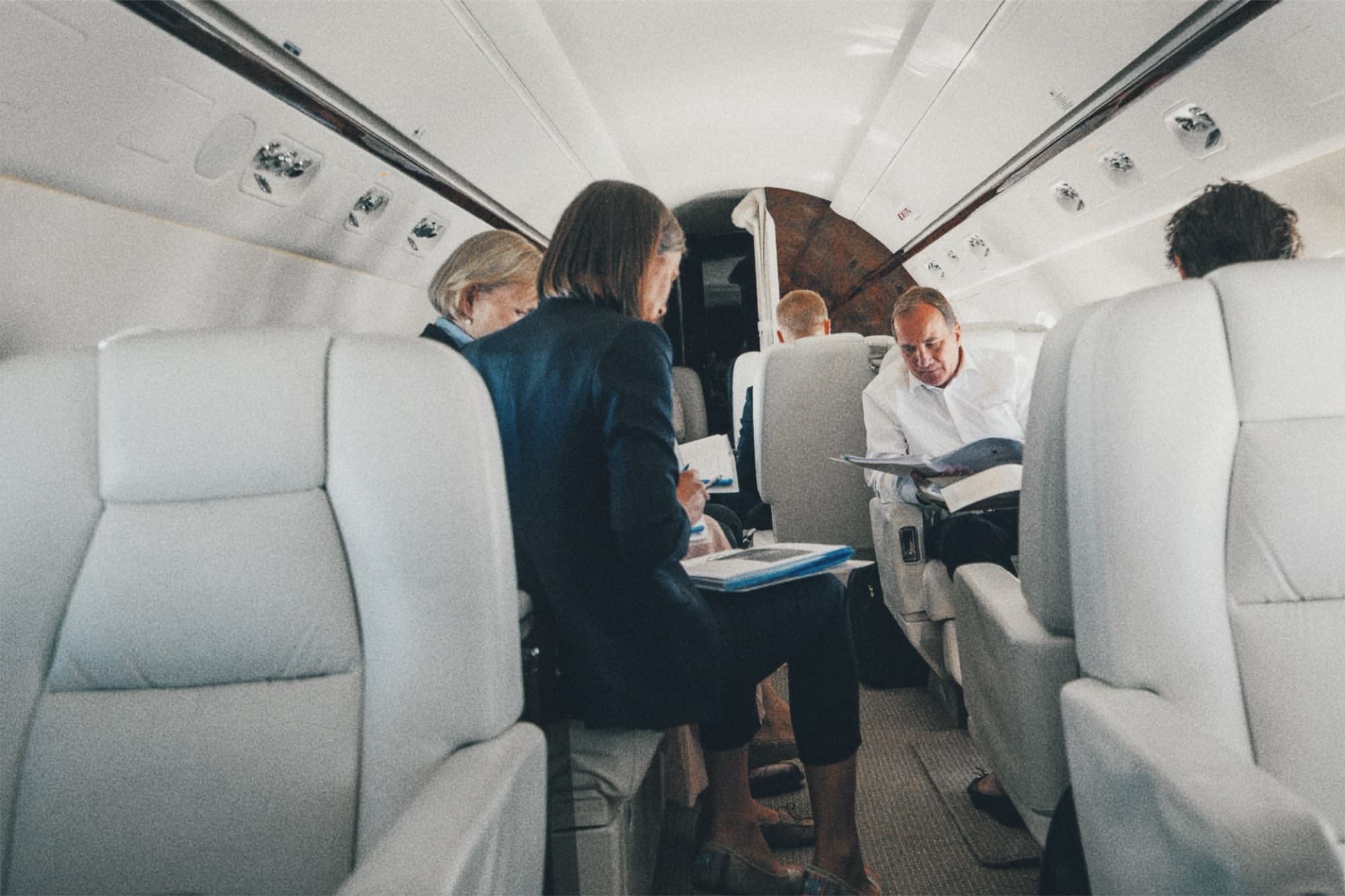 Colleagues reviewing papers inside an aircraft cabin